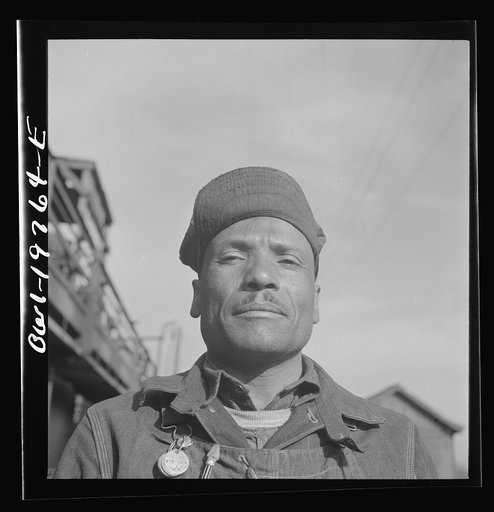 Topeka, Kansas. Manny Hughes, steel car repairer's helper and rivet heater, at the car shops of the Atchison, Topeka and Santa Fe Railroad