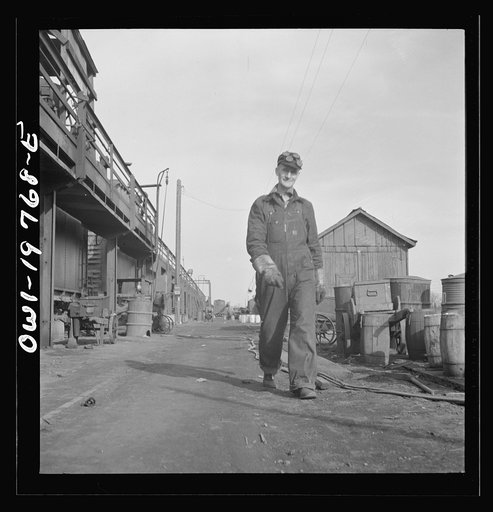Untitled photo, possibly related to: Topeka, Kansas. Claude Sweangen, steel car repairer, at the car shops of the Atchison, Topeka and Santa Fe Railroad