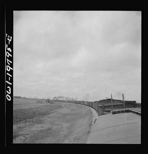 Emporia, Kansas. Crossing farm land along the Atchison, Topeka, and Santa Fe Railroad between Argentine and Emporia, Kansas