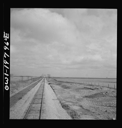 Emporia (vicinity), Kansas. Crossing farm land along the Atchison, Topeka, and Santa Fe Railroad