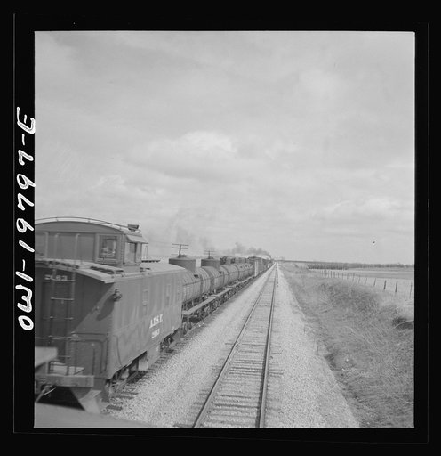 Untitled photo, possibly related to: Emporia, Kansas. An Atchison, Topeka, and Santa Fe train between Argentine and Emporia, Kansas passing an eastbound freight train
