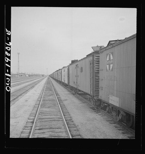 Untitled photo, possibly related to: Emporia, Kansas. An Atchison, Topeka, and Santa Fe train between Argentine and Emporia, Kansas passing an eastbound freight train