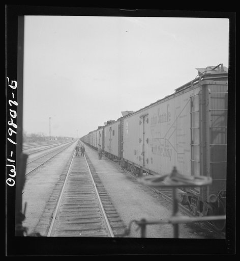 Untitled photo, possibly related to: Emporia, Kansas. An Atchison, Topeka, and Santa Fe train between Argentine and Emporia, Kansas passing an eastbound freight train
