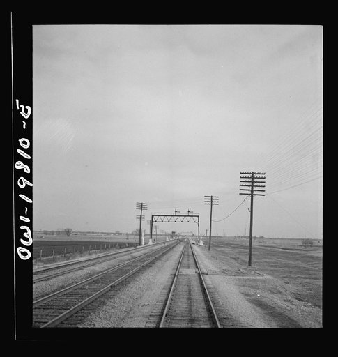 Untitled photo, possibly related to: An Atchison, Topeka, and Santa Fe passenger train passing through the Flint mills district of Kansas. This is a famous stock feeding area
