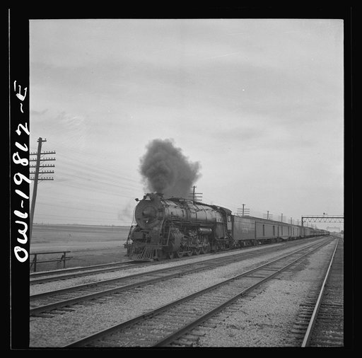 An Atchison, Topeka, and Santa Fe passenger train passing through the Flint Hills district of Kansas. This is a famous stock feeding area