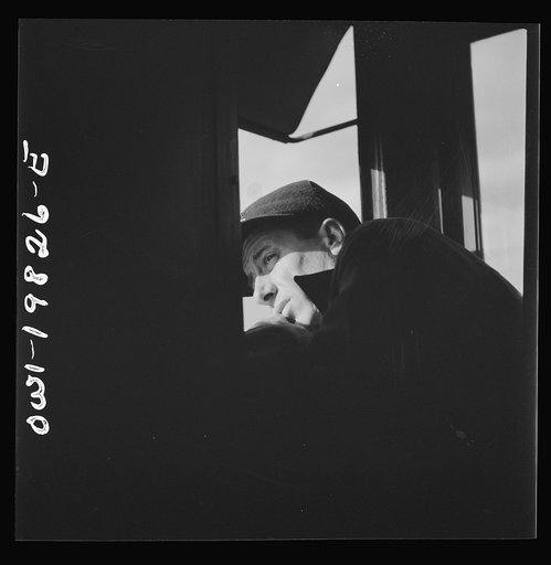 Brakeman H. L. Duffield, watching the train from the window in the cupola of the caboose on the Atchison, Topeka, and Santa Fe Railroad between Emporia and Wellington, Kansas