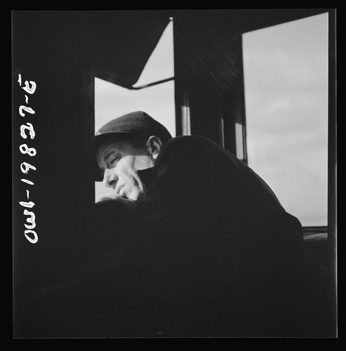 Untitled photo, possibly related to: Brakeman H. L. Duffield, watching the train from the window in the cupola of the caboose on the Atchison, Topeka, and Santa Fe Railroad between Emporia and Wellington, Kansas