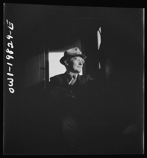 Untitled photo, possibly related to: Conductor W. E. Zink, watching the train from his window in the cupola of the caboose on the Atchison, Topeka, and Santa Fe Railroad between Emporia and Wellington, Kansas