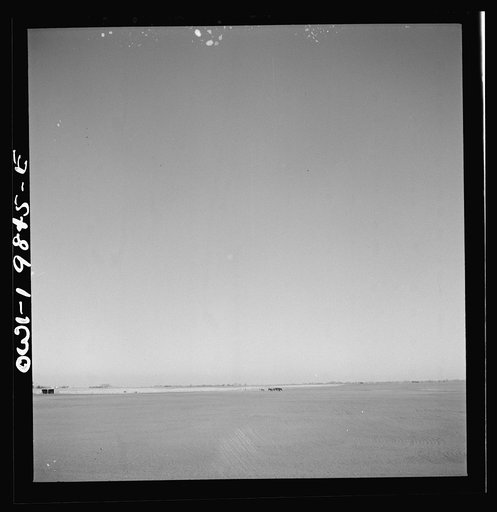 Argonis, Kansas. Crossing wheat fields along the Atchison, Topeka and Santa Fe Railroad between Wellington, Kansas and Waynoka, Oklahoma