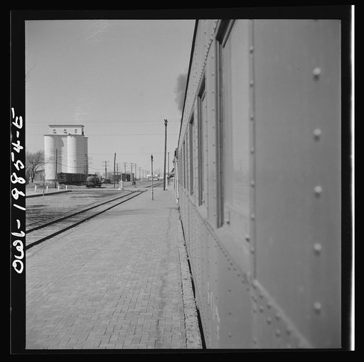 Untitled photo, possibly related to: Kiowa, Kansas. Train waiting for a block signal along the Atchison, Topeka and Santa Fe Railroad between Wellington, Kansas and Waynoka, Oklahoma