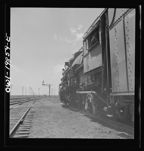 Kiowa, Kansas. Train waiting for a block signal along the Atchison, Topeka and Santa Fe Railroad between Wellington, Kansas and Waynoka, Oklahoma