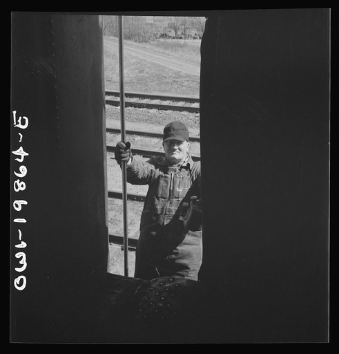 Kiowa, Kansas. Engineer B. F. Hale climbing back into the locomotive as the train is about to start on the Atchison, Topeka and Santa Fe Railroad between Wellington, Kansas and Waynoka, Oklahoma