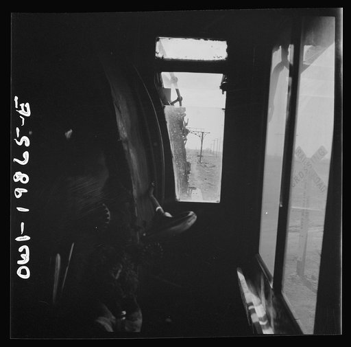 Untitled photo, possibly related to: Kiowa, Kansas. The engineer's window in the cab of a locomotive. Waiting for block signal to change on the Atchison, Topeka, and Santa Fe Railroad between Wellington, Kansas and Waynoka, Oklahoma
