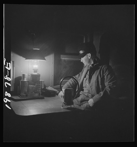 Untitled photo, possibly related to: Waynoka, Oklahoma. Brakeman Jack Torbet, sitting at the window of the caboose pulling out of Waynoka, Oklahoma on the Atchison, Topeka, and Santa Fe Railroad