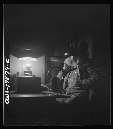 Waynoka, Oklahoma. Brakeman Jack Torbet, sitting at the window of the caboose pulling out of Waynoka, Oklahoma on the Atchison, Topeka, and Santa Fe Railroad