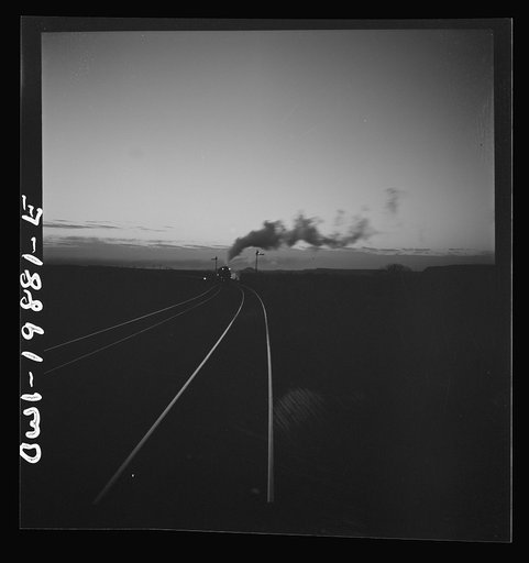 Belva, Oklahoma. Helper engine coming to help push the train on the Atchison, Topeka, and Santa Fe Railroad as far as Curtis, Oklahoma
