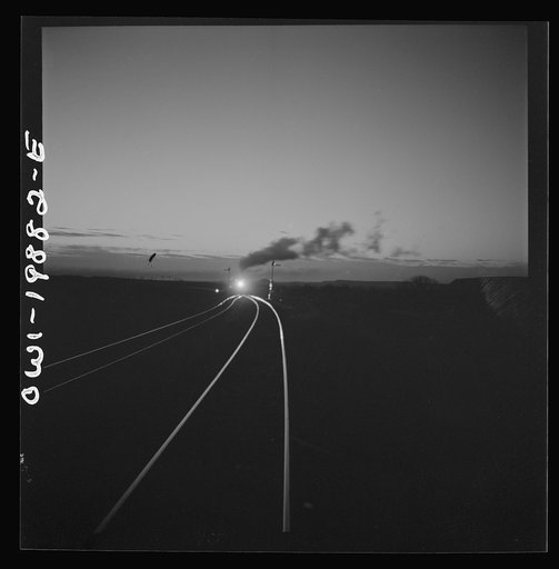 Belva, Oklahoma. Helper engine coming to help push the train on the Atchison, Topeka, and Santa Fe Railroad as far as Curtis, Oklahoma