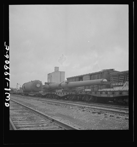 Untitled photo, possibly related to: Wellington, Kansas. A huge naval gun bound for the West coast in the Atchison, Topeka and Santa Fe Railroad yard