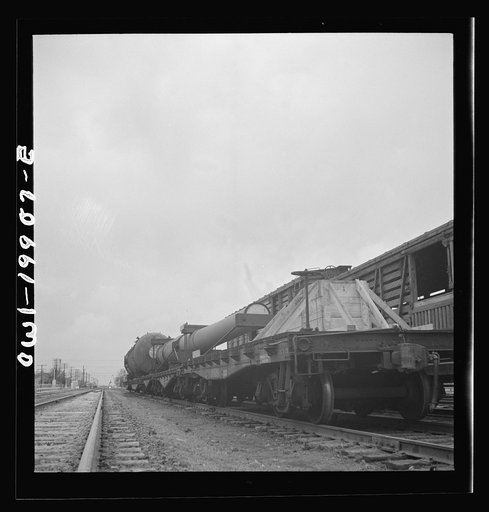 Untitled photo, possibly related to: Wellington, Kansas. A huge naval gun bound for the West coast in the Atchison, Topeka and Santa Fe Railroad yard
