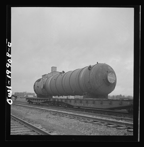 Untitled photo, possibly related to: Wellington, Kansas. A huge naval gun bound for the West coast in the Atchison, Topeka and Santa Fe Railroad yard