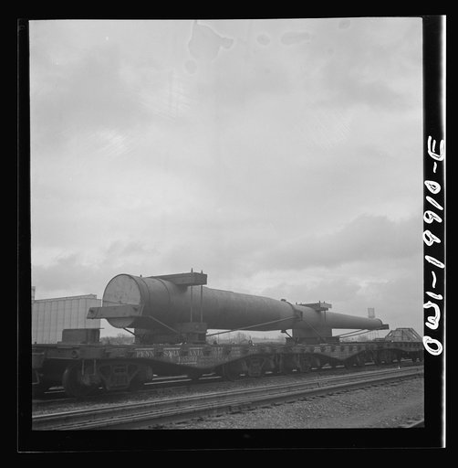 Untitled photo, possibly related to: Wellington, Kansas. A huge naval gun bound for the West coast in the Atchison, Topeka and Santa Fe Railroad yard