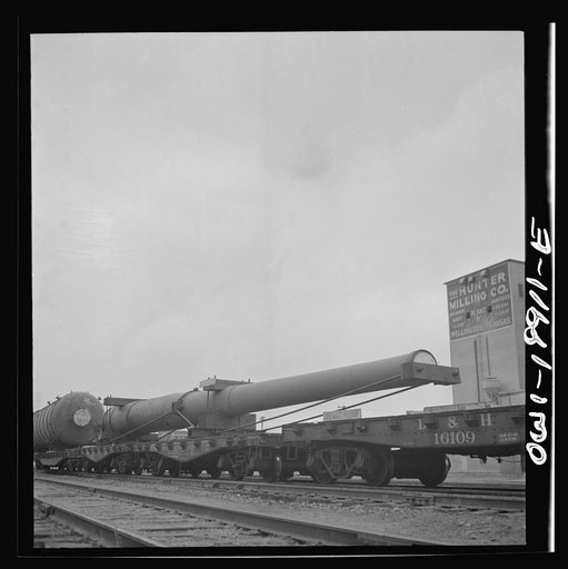 Untitled photo, possibly related to: Wellington, Kansas. A huge naval gun bound for the West coast in the Atchison, Topeka and Santa Fe Railroad yard