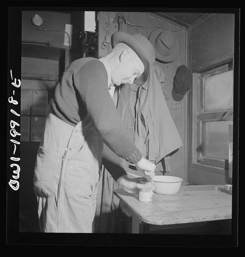 Brakeman Jack W. Torbet preparing lunch on the caboose on the Atchison, Topeka and Santa Fe Railroad between Waynoka, Oklahoma and Canadian, Texas