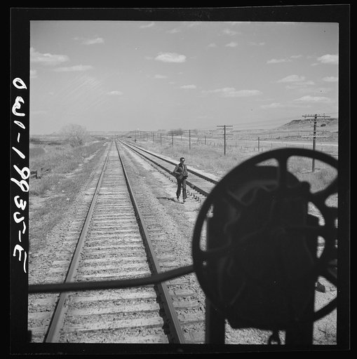 Miami, Texas. On the Atchison, Topeka and Santa Fe Railroad between Canadian, Texas and Amarillo, Texas. Rear brakeman running back to train as it gets ready to start again after having taken water