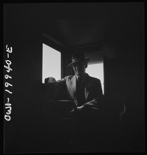 Untitled photo, possibly related to: Conductor J.R. Crawford, watching the train from his window in the cupola of the caboose along the Atchison, Topeka, and Santa Fe Railroad between Canadian and Amarillo, Texas