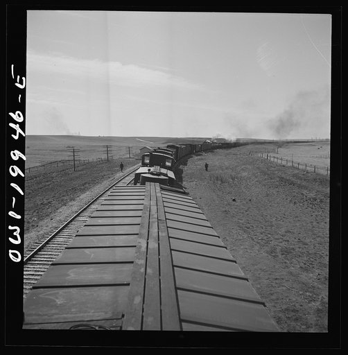 Hoover, Texas. An Atchison, Topeka, and Santa Fe train stopping to let an east-bound freight go by between Canadian and Amarillo, Texas