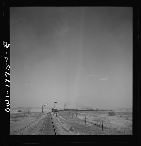Untitled photo, possibly related to: Hoover, Texas. An Atchison, Topeka, and Santa Fe train stopping to let an east-bound freight go by between Canadian and Amarillo, Texas