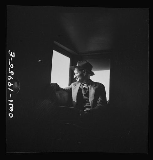 Untitled photo, possibly related to: Conductor J.R. Crawford, watching the train from his window in the cupola of the caboose along the Atchison, Topeka, and Santa Fe Railroad between Canadian and Amarillo, Texas