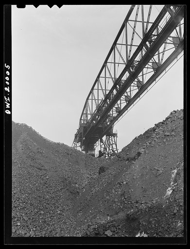 Untitled photo, possibly related to: Milwaukee Western Fuel Company, Milwaukee, Wisconsin. One of the bridges at the Seventeenth Street dock of the Milwaukee Western Fuel Company with a five-ton coal bucket. The bridge is used for unloading ships, loading cars, keeping coal over the tunnel and loadi