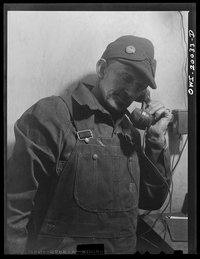 Untitled photo, possibly related to: Milwaukee Western Fuel Company, Milwaukee, Wisconsin. Worker in a processing plant using the telephone to communicate with the tunnel at the Milwaukee Western Fuel Company