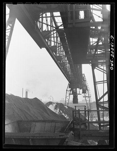 Untitled photo, possibly related to: Milwaukee Western Fuel Company, Milwaukee, Wisconsin. One of the bridges at the Seventeenth Street dock of the Milwaukee Western Fuel Copany with a five-ton coal bucket. The bridge is used for unloading ships, loading cars, keeping coal over the tunnel and loadin