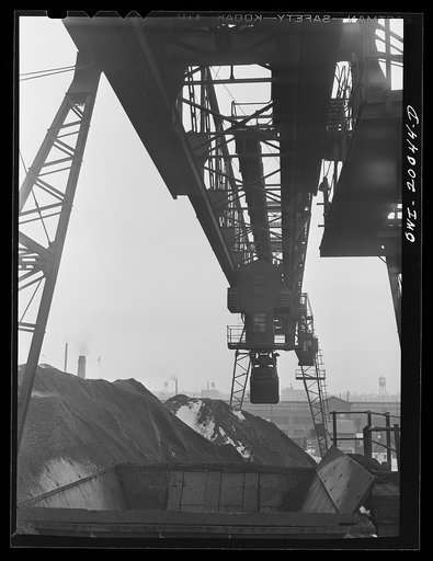 Untitled photo, possibly related to: Milwaukee Western Fuel Company, Milwaukee, Wisconsin. One of the bridges at the Seventeenth Street dock of the Milwaukee Western Fuel Copany with a five-ton coal bucket. The bridge is used for unloading ships, loading cars, keeping coal over the tunnel and loadin