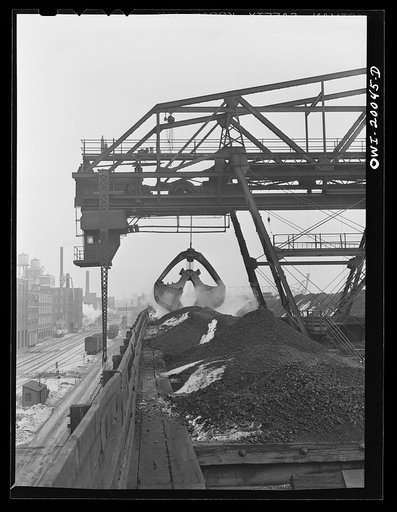 Milwaukee Western Fuel Company, Milwaukee, Wisconsin. Ten-ton bucket of the Milwaukee Western Fuel Company's Fourteenth Street dock bridge loading coal into the hoppers. The thin tapering girder reaching down from the cab on the left connects with a moving trolley on electric cables which supply pow