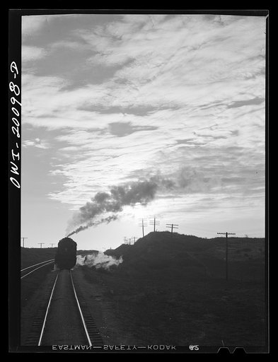 Untitled photo, possibly related to: Curtis, Oklahoma. Helper engine leaving an Atchison, Topeka and Santa Fe train early in the morning after having helped push it from Belva, Oklahoma
