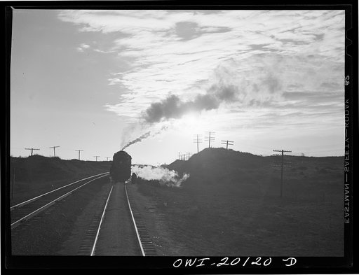Untitled photo, possibly related to: Curtis, Oklahoma. Helper engine leaving an Atchison, Topeka and Santa Fe train early in the morning after having helped push it from Belva, Oklahoma