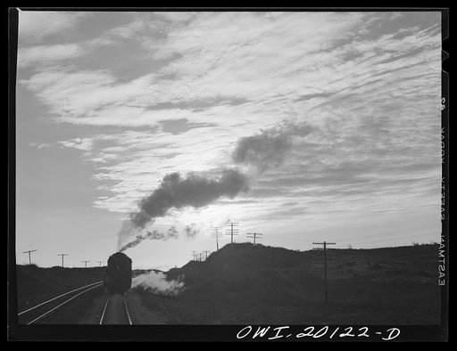 Curtis, Oklahoma. Helper engine leaving an Atchison, Topeka and Santa Fe train early in the morning after having helped push it from Belva, Oklahoma