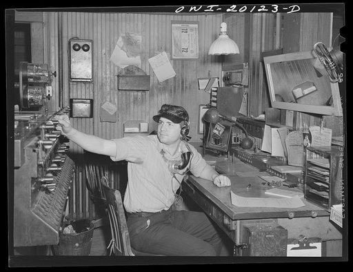 Waynoka, Oklahoma. An Atchison, Topeka and Santa Fe operator and telegrapher throwing one of the interlocking switches