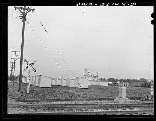 Emporia, Kansas. Passing the Kansas soybean mill inc. on an Atchison, Topeka and Santa Fe train. There are fifty storage bins, each holding 2800 bushels. The plant processes soybeans for oil and feed