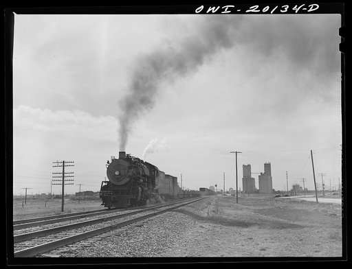Amarillo, Texas. Eastbound Atchison, Topeka and Santa Fe freight train leaving the city