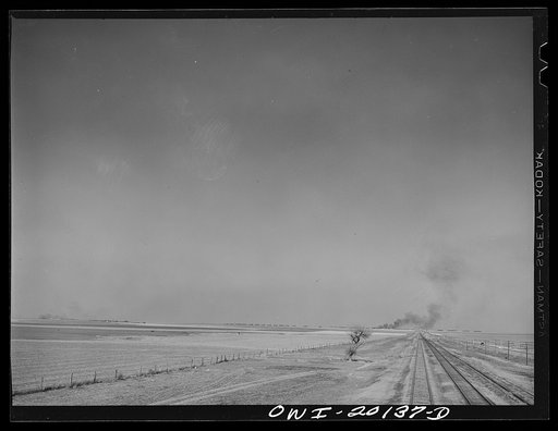 Farm lands and oil storage tanks west of Pampa, Texas along the tracks of the Atchison, Topeka and Santa Fe Railroad