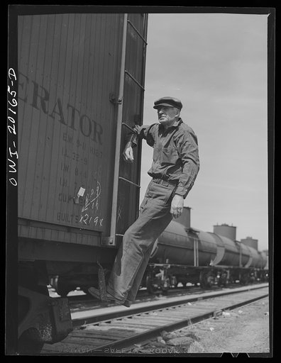 Amarillo, Texas. R.W. Simmons, an Atchison, Topeka and Santa Fe engine foreman, riding a car in the railroad yard