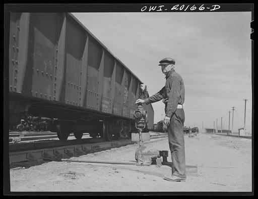 Untitled photo, possibly related to: Amarillo, Texas. R.W. Simmons, an Atchison, Topeka and Santa Fe engine foreman, riding a car in the railroad yard