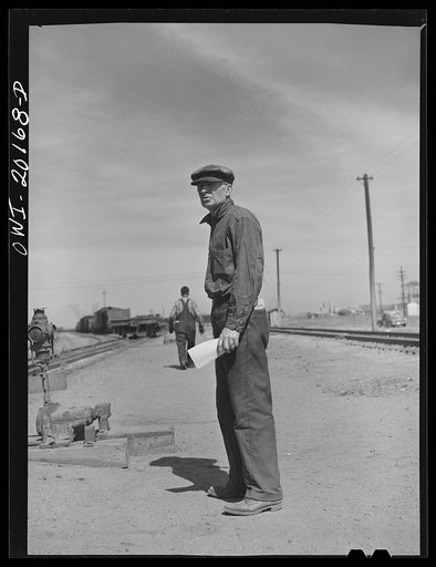 Untitled photo, possibly related to: Amarillo, Texas. R.W. Simmons, an Atchison, Topeka and Santa Fe engine foreman, riding a car in the railroad yard