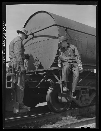 Amarillo, Texas. Atchison, Topeka and Santa Fe switchman riding cars in the yards