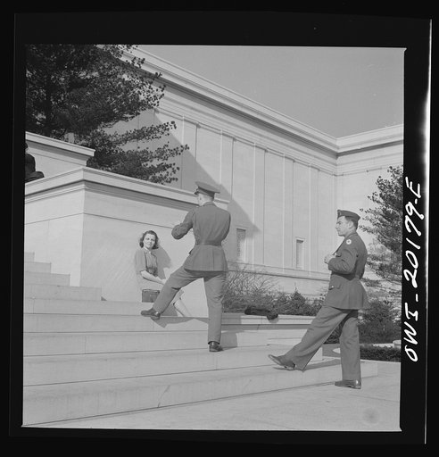 Washington, D.C. Soilders taking a picture of his girlfriend on the steps of the National Gallery of Art on a Sunday afternoon