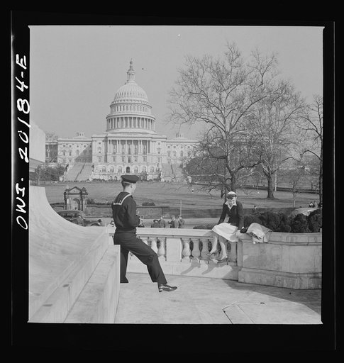Washington, D.C. Sailor taking a picture of his girlfriend at a monument in front of the Capitol on a Sunday afternoon